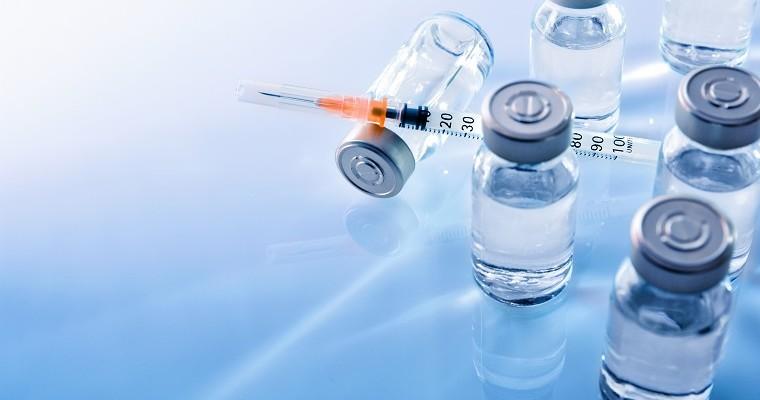 Szczepionki - fiolki z substancją oraz strzykawki.