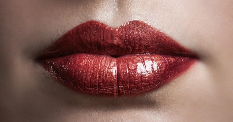 Kobiece usta pomalowane czerwoną szminką 
